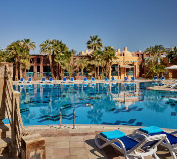 Adults pool of Sheraton Miramar 5 stars hotel El Gouna with the mix of beige exteriors and blue waters for relaxation mood