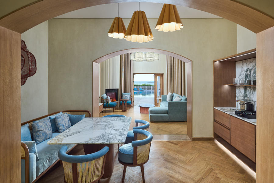 Presidiential uite dining table, seating area with sofa, view on the red sea and pool