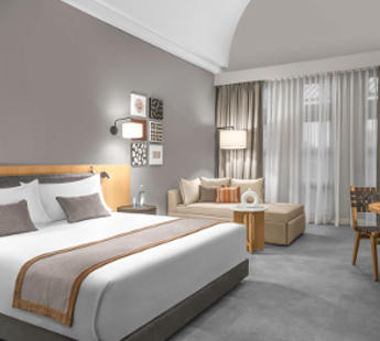 Renovated Deluxe Bedroom of Steigenberger Golf Resort El Gouna with a bed, couch and seating area