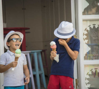 Two kids having fun and eating ice cream at Kids Club of Sheraton Miramar Resort in El Gouna