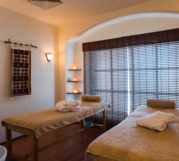 2 spa beds with relaxing lightings and hanged tapestry in Sheraton Miramar El Gouna Spa