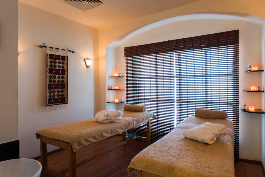 2 spa beds with relaxing lightings and hanged tapestry in Sheraton Miramar El Gouna Spa