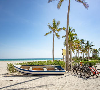 boat and bikes at the beach of Hawana salalah, Fanar Hotel Oman