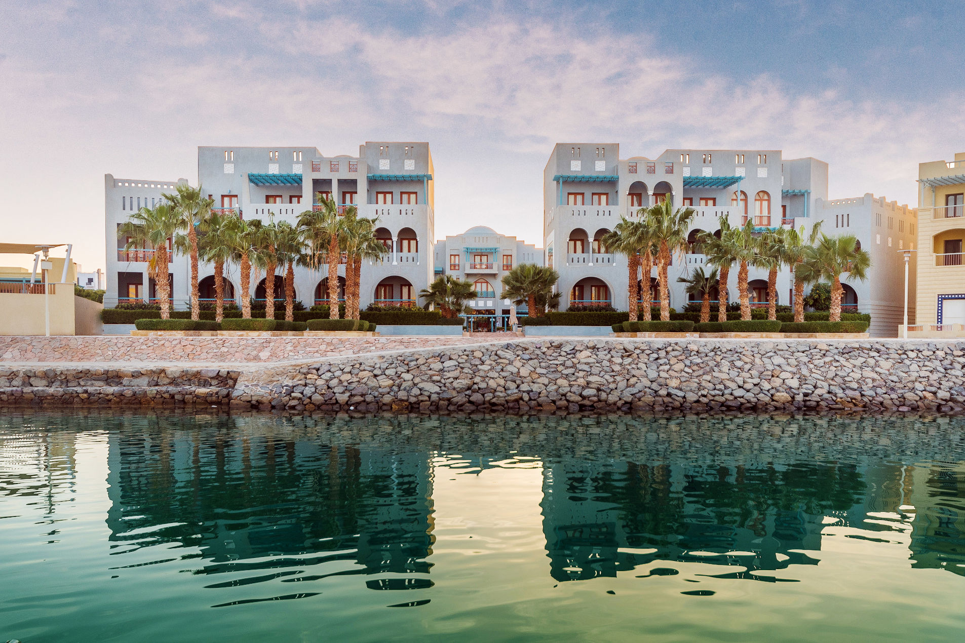 Overview of Fanadir Marina Hotel in El Gouna with a palette of blue and wooden brown from Abu Tig Marina Side