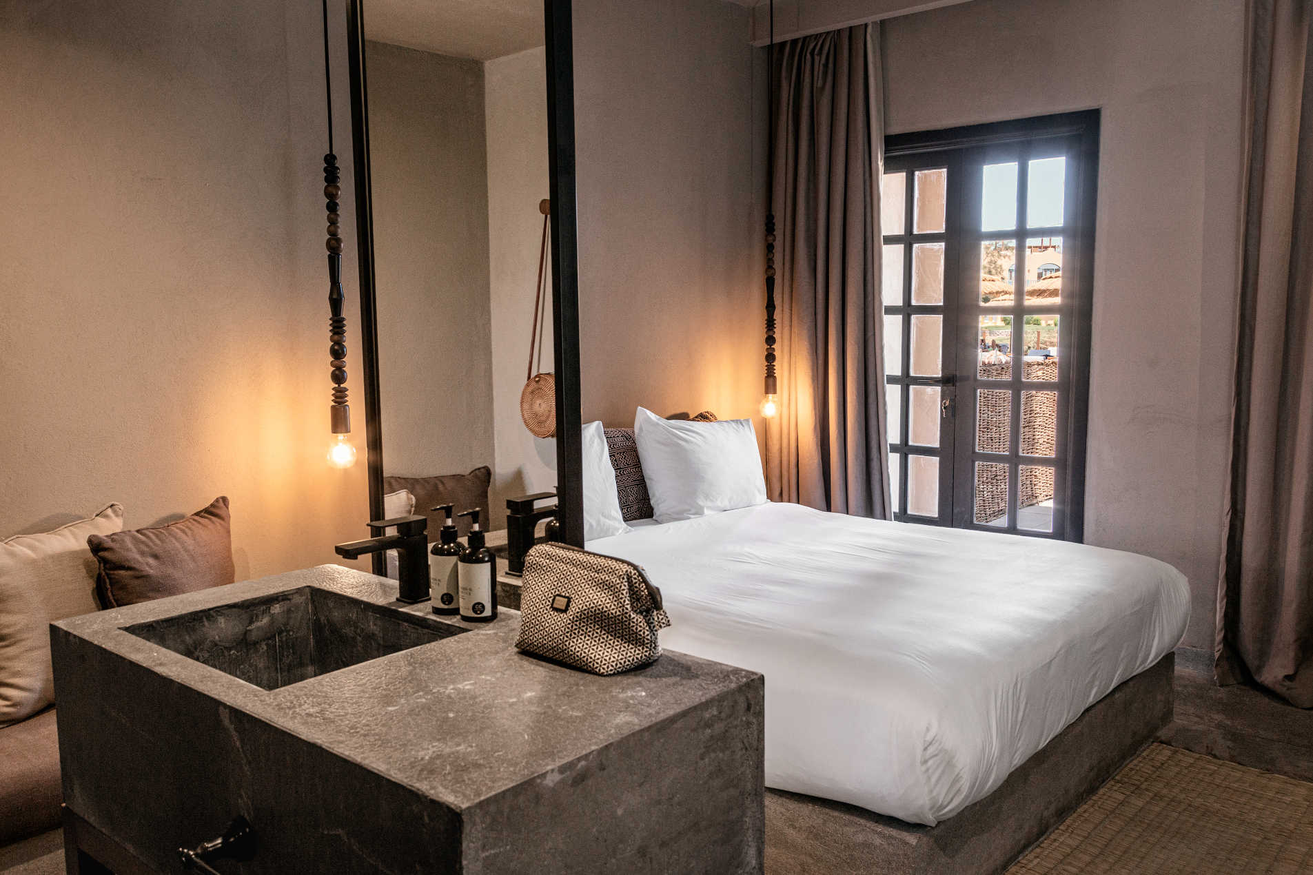 The kingbed room in Cook's Club with luxury beddings and a french door with a mirror for El Gouna luxury accommodation