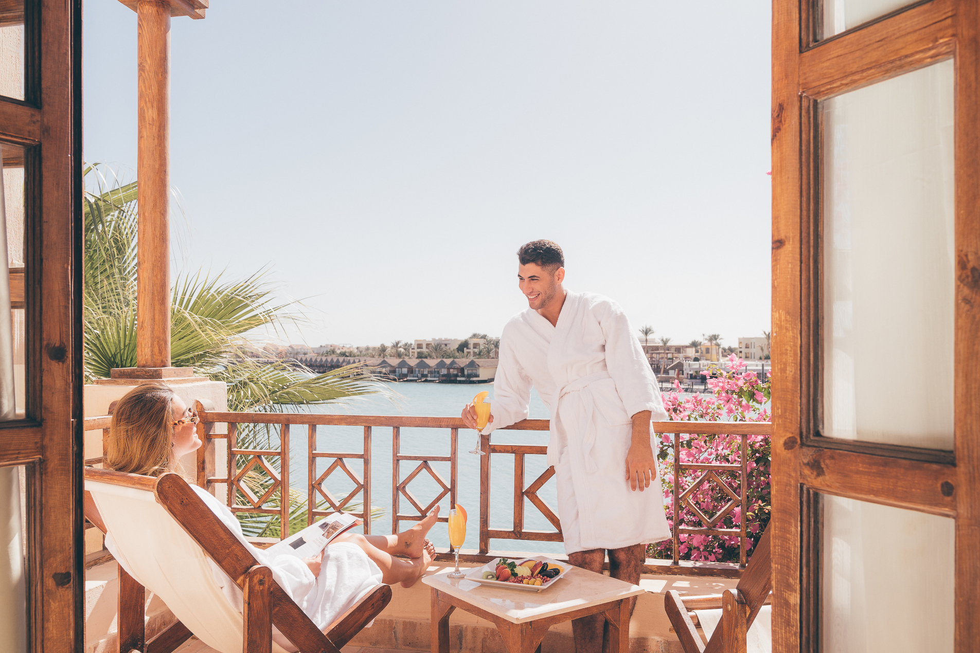 a man and a woman hanging out in the terrace window at sultan bey hotel