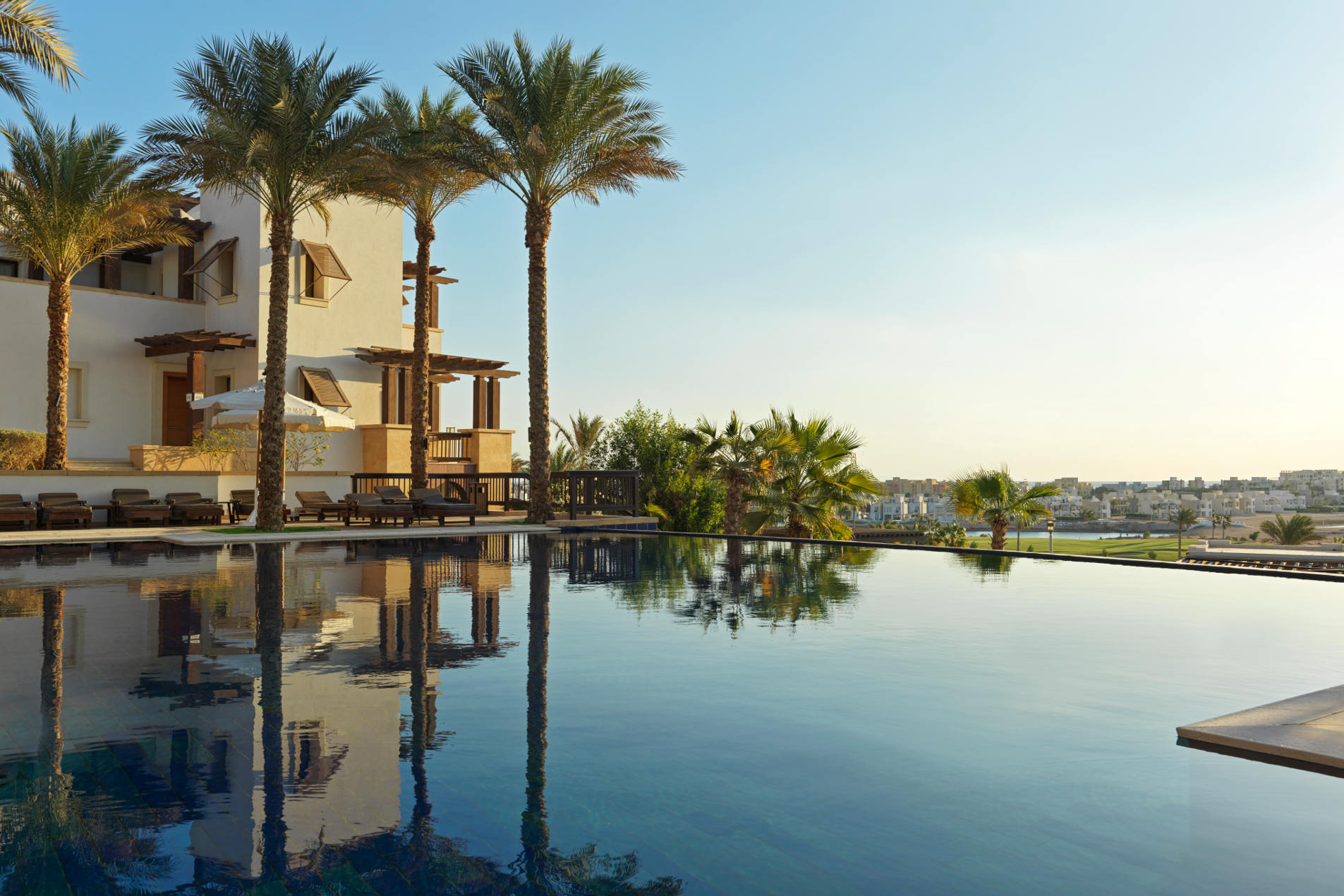 pool area with seating and architect view at ancient sands hotel el gouna