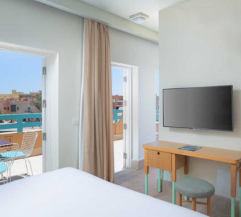 Captain's Inn Hotel El Gouna marina Suite with Abu Tig Marina view terrace & furnished with king bed & flat screen TV ahead