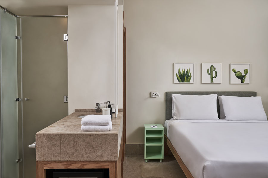 Captain's Inn El Gouna Red Sea Egypt Junior Suite King bed, mini bar also the Bathroom shower and basin appear on the left