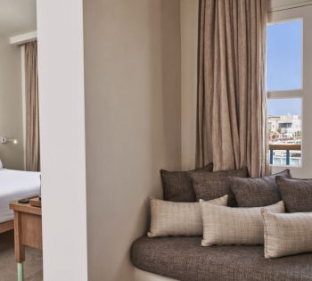Captain's Inn Hotel El Gouna Junior Suite with King size bed, marina view window & a comfy seating Sofa with cushions