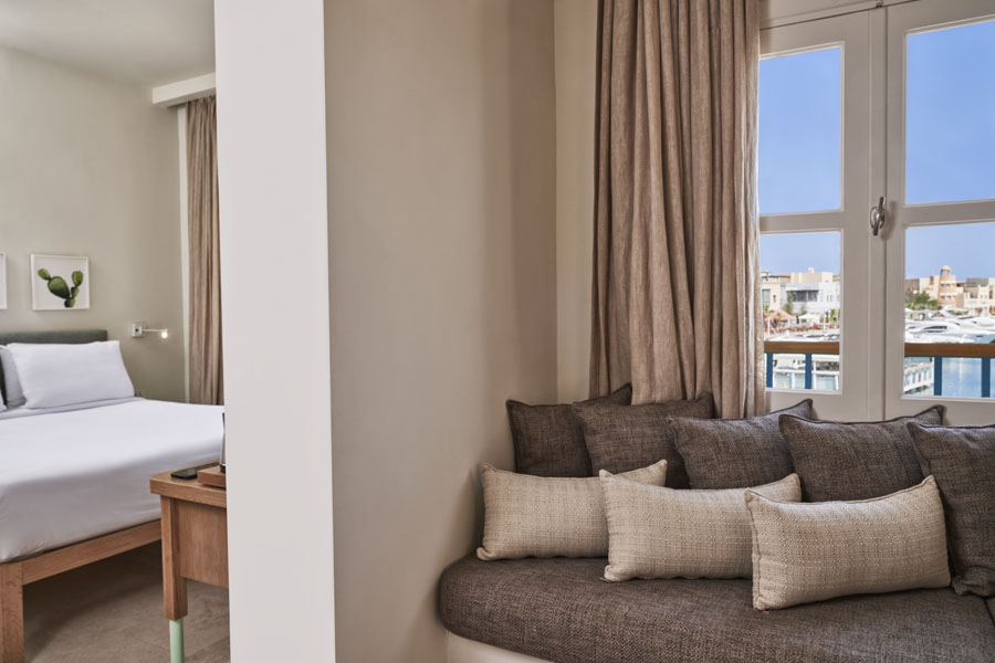 Captain's Inn Hotel El Gouna Junior Suite with King size bed, marina view window & a comfy seating Sofa with cushions
