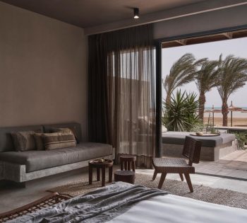 The outdoor terrace of junior suite in sofas overlooking the shared pool of Red Sea at Casa Cook hotel in El Gouna Egypt