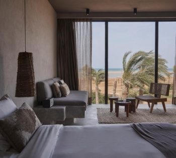 The king bedroom of premium room with spacious sitting area and out door terrace with Red Sea view at Casa Cook El Gouna luxury resort