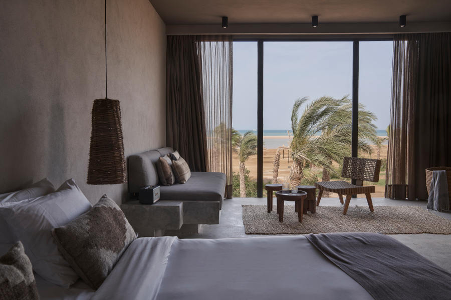 The king bedroom of premium room with spacious sitting area and out door terrace with Red Sea view at Casa Cook El Gouna luxury resort