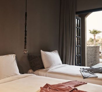 The twin bedroom of lagoon view room at Cook's Club El Gouna served with 2 shower robes