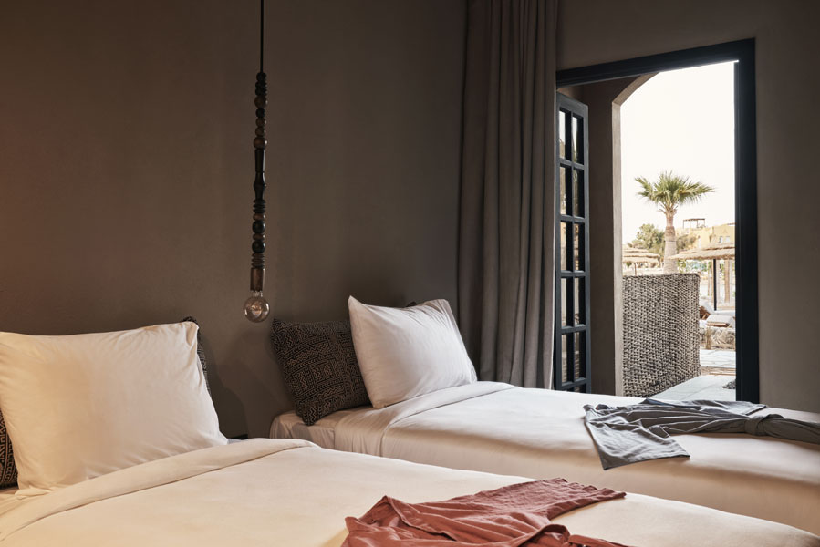The twin bedroom of lagoon view room at Cook's Club El Gouna served with 2 shower robes