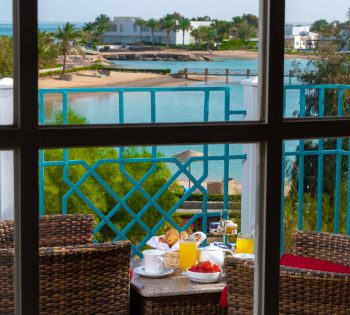 Deluxe Lagoon View Room Terrace Breakfast of Mövenpick Resort and Spa El Gouna with beach and greenery view