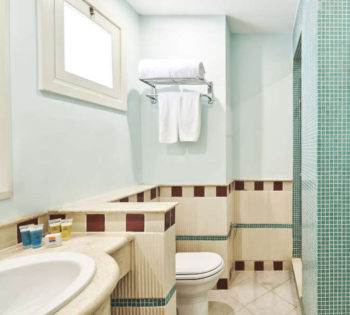 Turqouise beige marbeled bathroom of Junior Suite and tub with mirror and makeup mirror at Fanadir New Marina Hotel El Gouna