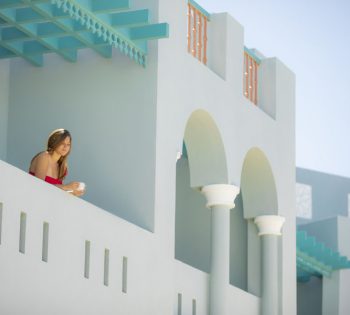 The terrace of Standard rooms with a guest having her coffee at Fanadir New Marina Hotel in El Gouna