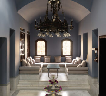 a chandelier, a water fountain, and a seating area at the spa at la maison blueue