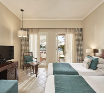 2 twin beds of Mosaique Hotel accessible room and a wide glass windows with a pool view terrace in El Gouna Egypt