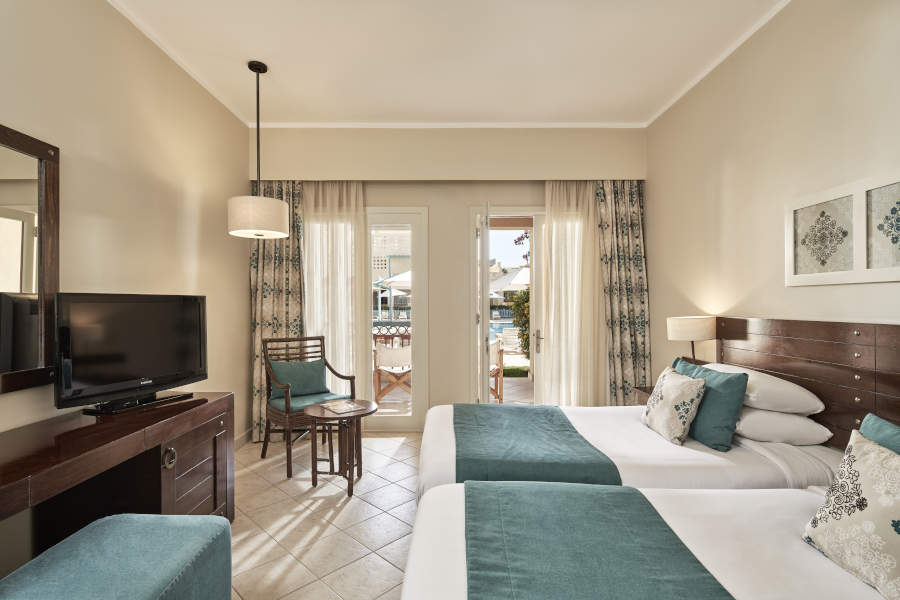 2 twin beds of Mosaique Hotel accessible room and a wide glass windows with a pool view terrace in El Gouna Egypt