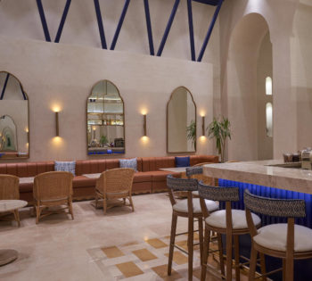 lobby bar with high chair, brown sofa and blue wodden structure