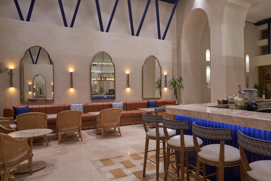 lobby bar with high chair, brown sofa and blue wodden structure