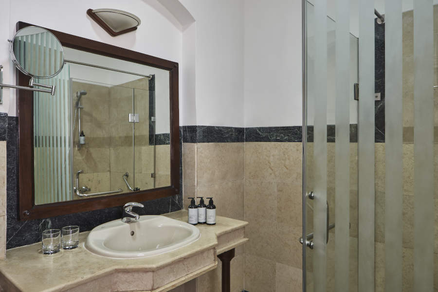 bathroom sink and shower area at sultan bey lagoon view room