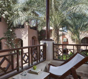 terrace seating area with garden view at standard room in sultan bey hotel