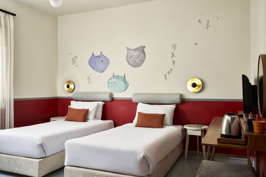 Fire theme colorful standard room with twin bed, flat screen TV at Turtl'es Inn Hotel El Gouna Red Sea Egypt holiday retreat