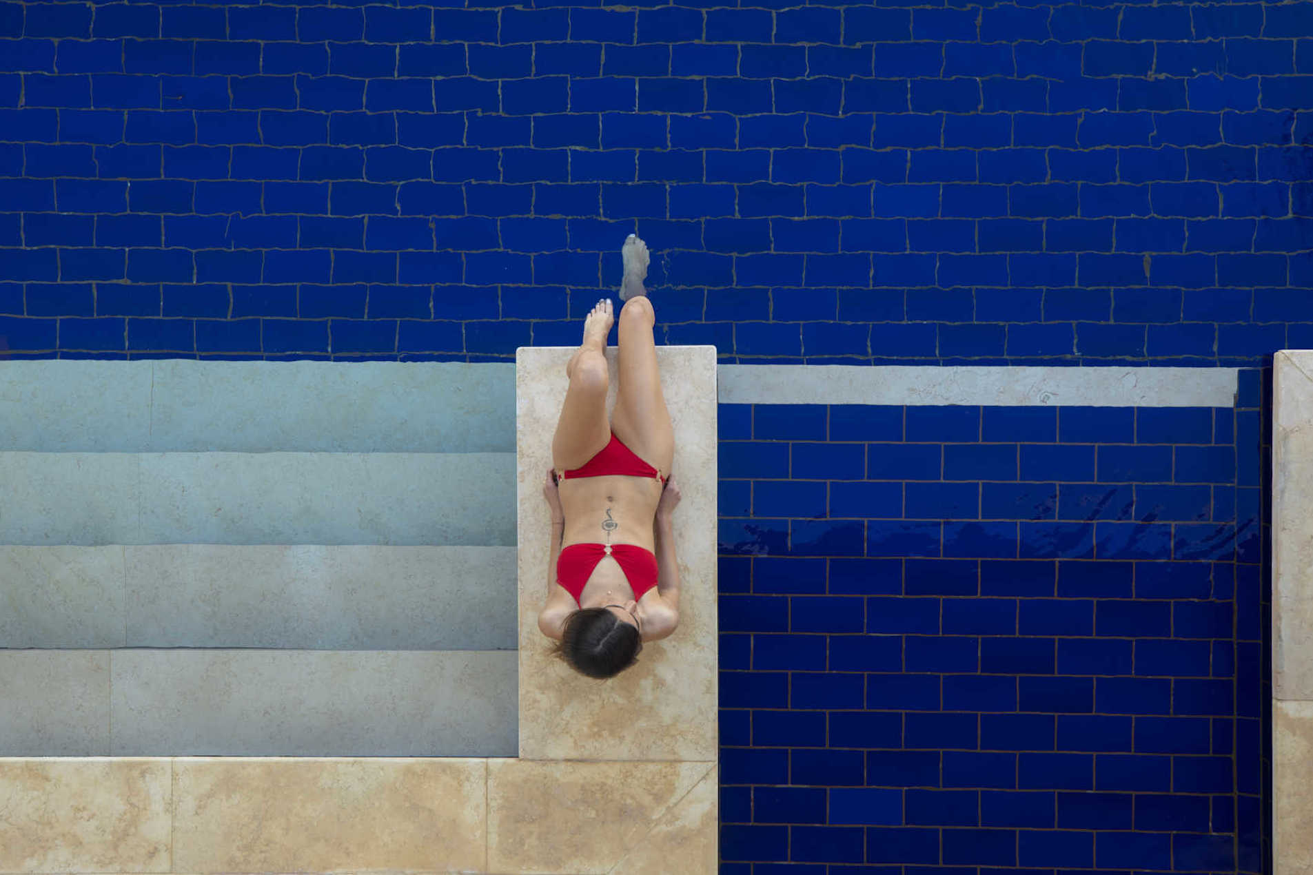 A bird view of a girl chilling out at Ancient Sands El Gouna Resort Pool