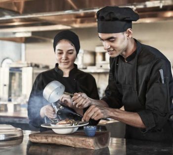 Two chefs are cooking live at The Kitchen Club of Casa Cook El Gouna Hotel