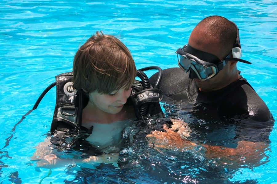 A diver with a kid from Orca Diving Center at the pool of Labranda Club Paradisio Hotel in El Gouna for a diving lesson