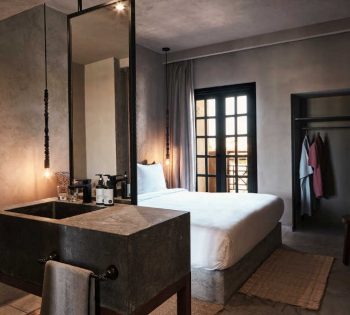 The overview of Lagoon View Room furnished with a king sized bed in Cook's Club Hotel El Gouna