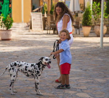 A kid with his mom and their dog feeling cheerful in El Gouna Red Sea