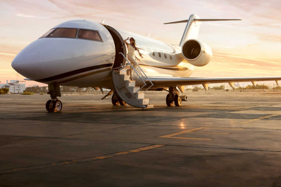 A lady is coming out of a private jet at El Gouna airport in Red Sea