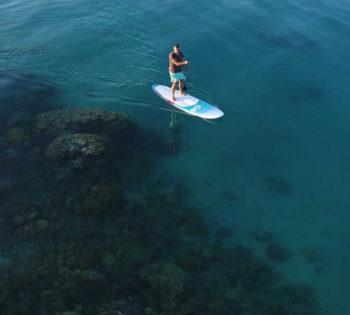 A man stand-up paddling in the heart of turquoise waters of Red Sea in El Gouna Egypt