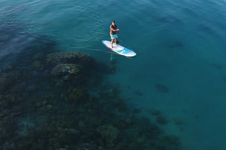 A man stand-up paddling in the heart of turquoise waters of Red Sea in El Gouna Egypt