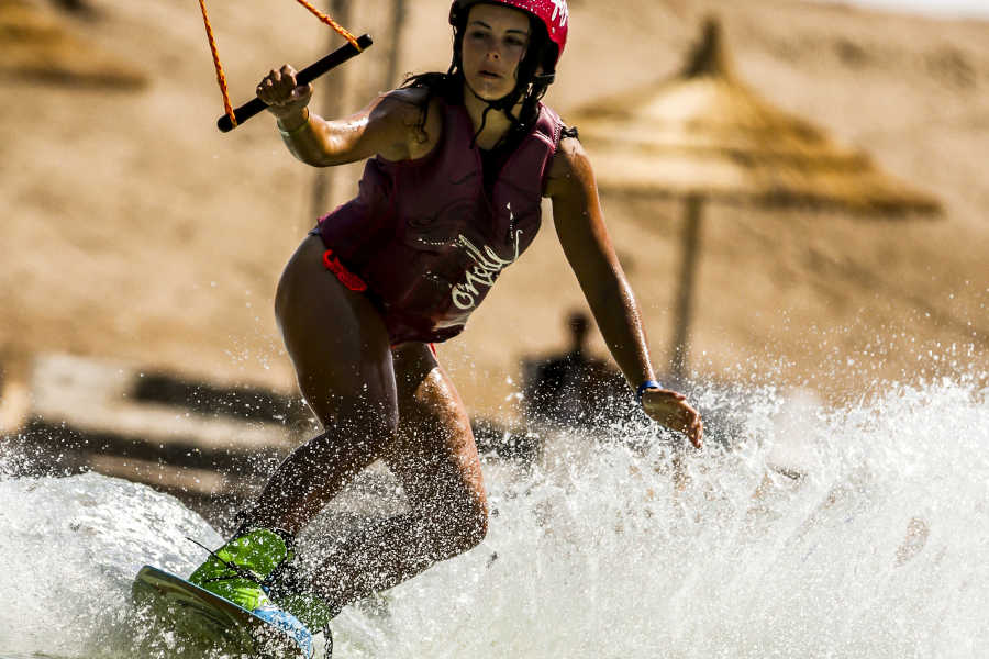 A girl is wakeboarding in El Gouna lagoons at Sliders Cable Park