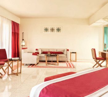 The spacious sitting area of Junior Suite in red beige theme at Club Paradisio Hotel in El Gouna