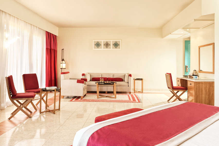 The spacious sitting area of Junior Suite in red beige theme at Club Paradisio Hotel in El Gouna