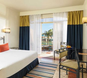 The king bed of club room in blue theme at Labranda Club Parardisio for a luxury stay in El Gouna Red Sea