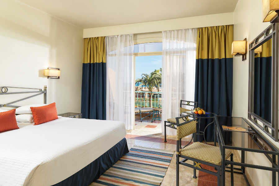 The king bed of club room in blue theme at Labranda Club Parardisio for a luxury stay in El Gouna Red Sea