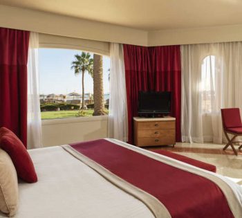 The king bed of Junior Suite in El Gouna with garden view at Club Paradisio Hotel