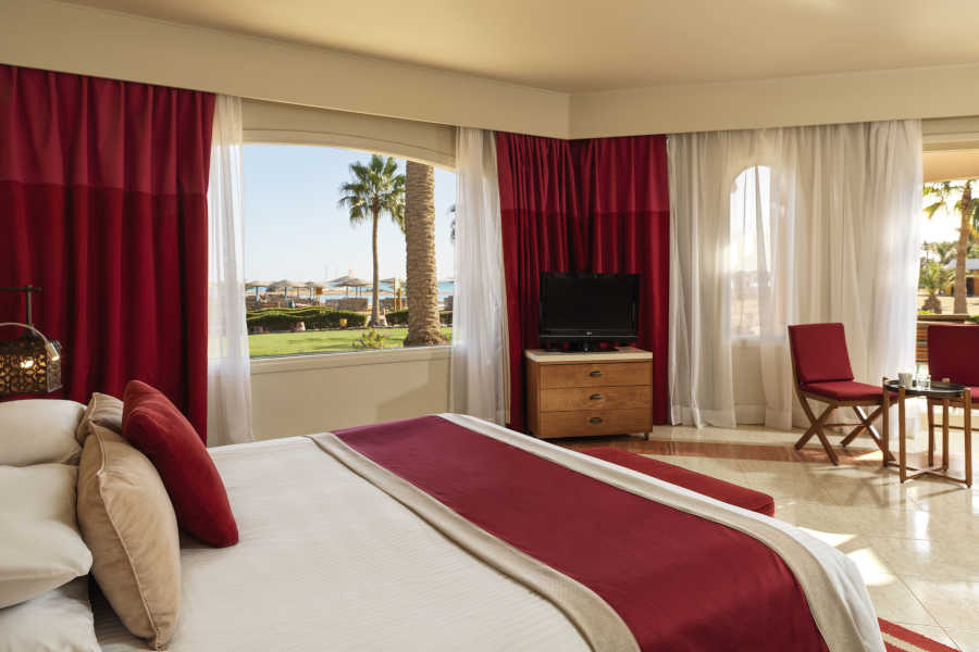 The king bed of Junior Suite in El Gouna with garden view at Club Paradisio Hotel