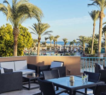 The outdoor area of lobby bar at El Gouna Hotel Labranda Club Paradisio with Red Sea and gardens view