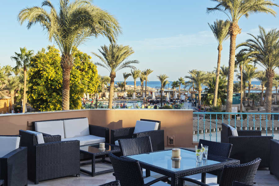 The outdoor area of lobby bar at El Gouna Hotel Labranda Club Paradisio with Red Sea and gardens view