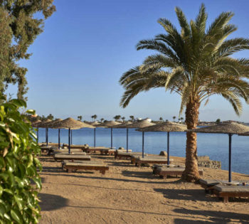 The private lagoon beach of Sultan Bey hotel in El Gouna with the stunning view of Red Sea lagoons and sunbeds