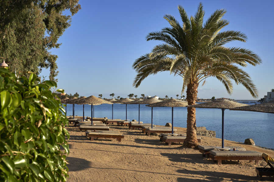 The private lagoon beach of Sultan Bey hotel in El Gouna with the stunning view of Red Sea lagoons and sunbeds